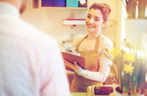 florist woman and man making order at flower shop